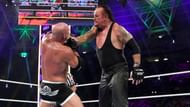 The Undertaker proceeds to choke out Goldberg during their
